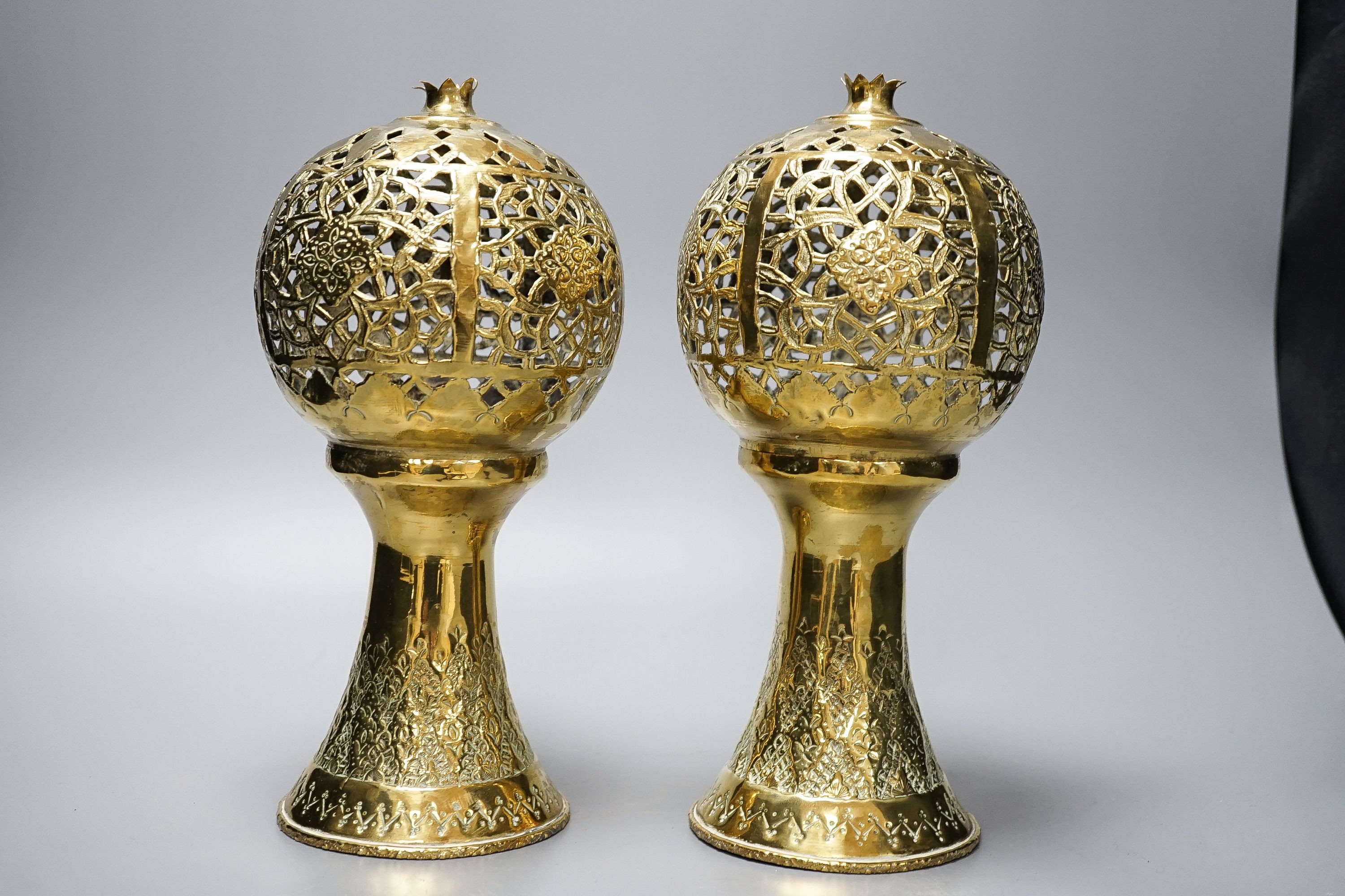 A pair of Indian brass incense burners, each of pomegranate form, 28cm